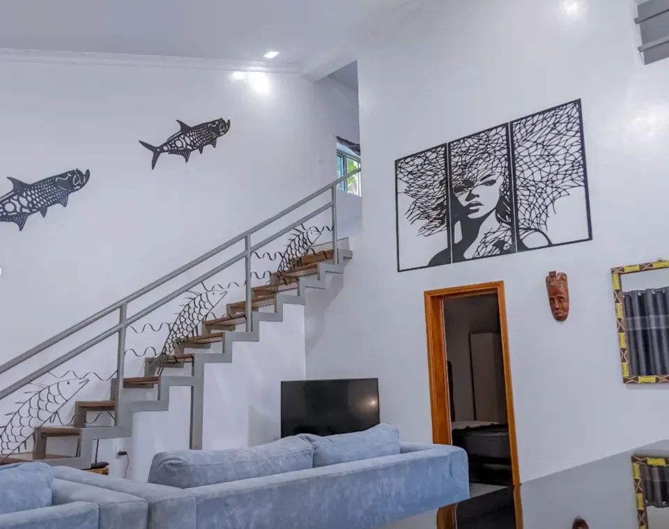 The double-height living room, with the staircase and wall art