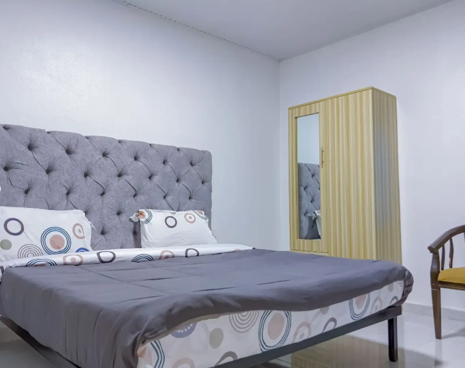 A bedroom, with a mirrored wardrobe