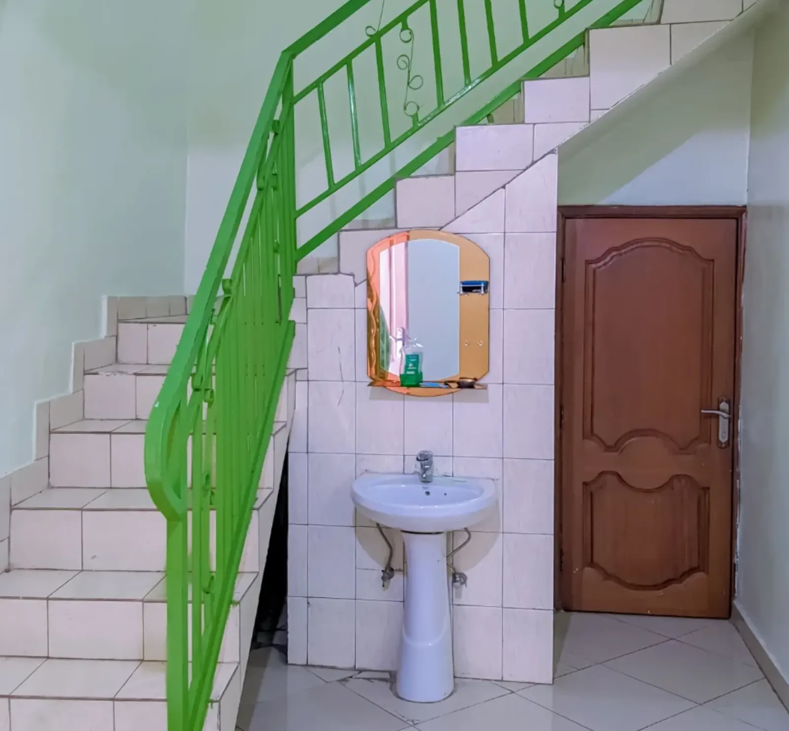 The stairs and the ground-floor washbasin