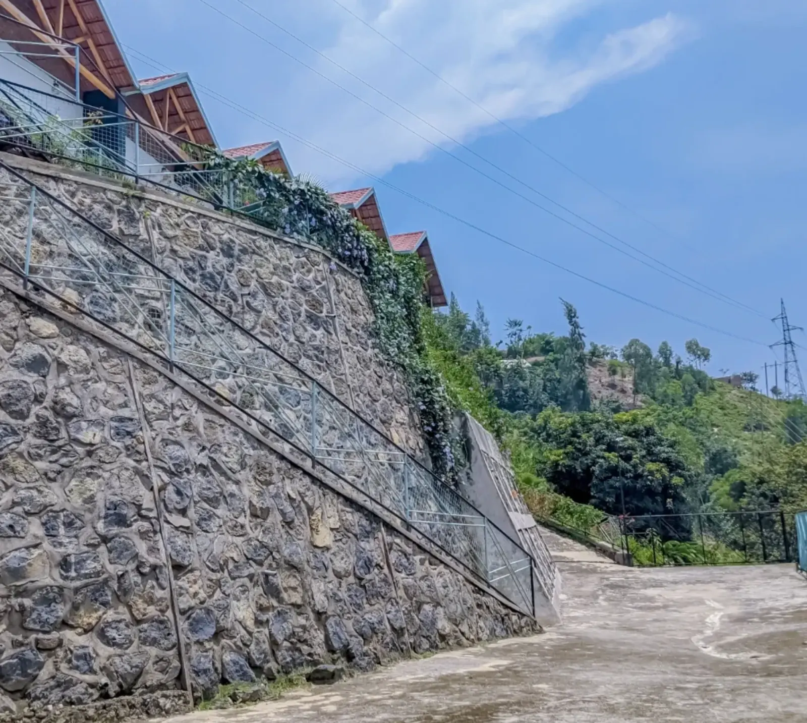 The stone wall the houses stand on, and the parking below